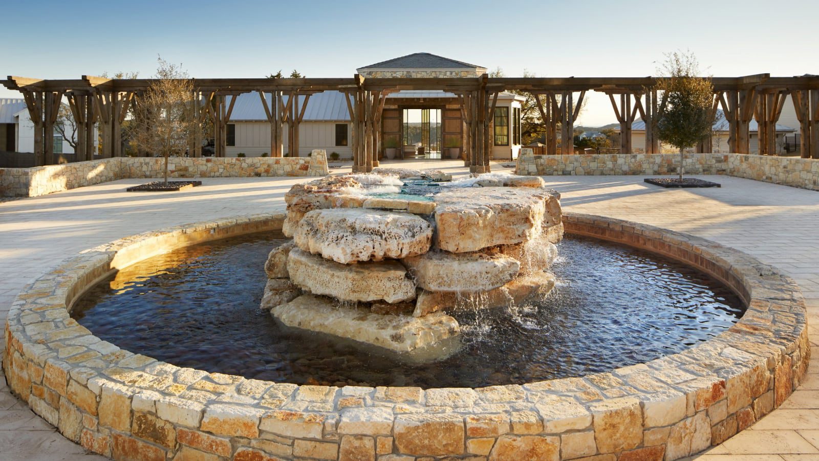 round outdoor water fountain with exterior of building