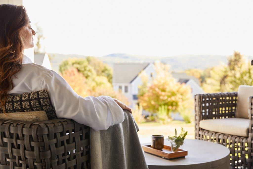 person relaxing on a chair outside